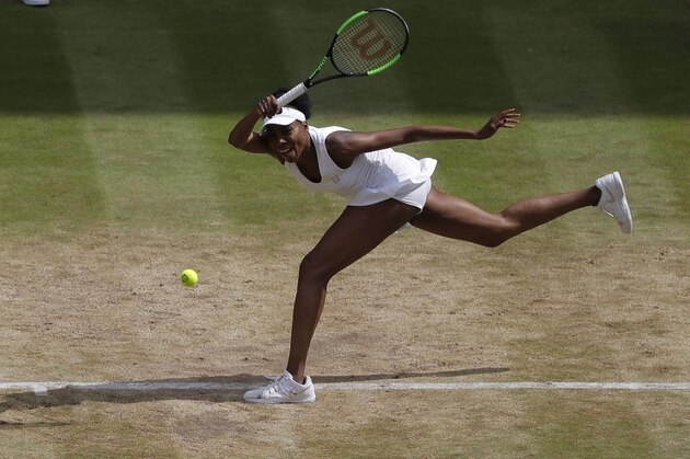 Venus Williams of the United States returns to Britain's Johanna Konta during their Women's Singles semifinal match on day nine at the Wimbledon Tennis Championships in London Thursday, July 13, 2017. (AP Photo/Alastair Grant)