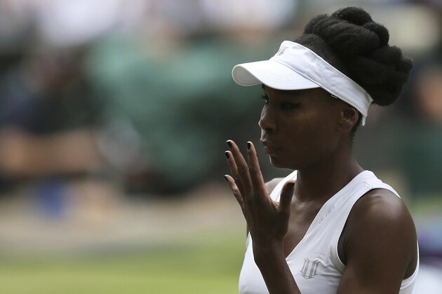 Venus Williams of the United States gestures for a towel to wipe her face as she plays Britain's Johanna Konta during their Women's Singles semifinal match on day nine at the Wimbledon Tennis Championships in London Thursday, July 13, 2017. (AP Photo/Tim Ireland)