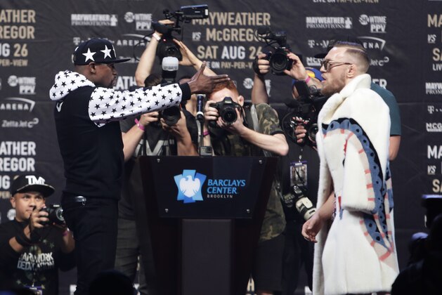 Floyd Mayweather Jr., left, and Conor McGregor exchange words during a news conference for their junior middleweight boxing bout, at Barclays Center on Thursday, July 13, 2017, in New York. (AP Photo/Frank Franklin II)