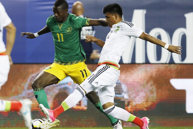 Jamaica forward Cory Burke, left, pursues the ball with Mexico midfielder Jesús Gallardo during the first half of a CONCACAF Gold Cup soccer match Thursday, July 13, 2017, in Denver. (AP Photo/David Zalubowski)