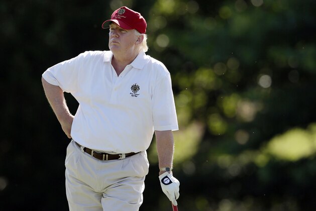 FILE - In this June 27, 2012, file photo, Donald Trump stands on the 14th fairway during a pro-am round of the AT&T National golf tournament at Congressional Country Club in Bethesda, Md. A set of golf clubs that Trump gifted to a former caddie before becoming president is being auctioned off. Boston-based RR Auction says Trump used the TaylorMade RAC TP ForgedIrons clubs at the Trump National Golf Club in Bedminster, New Jersey. (AP Photo/Patrick Semansky, File)