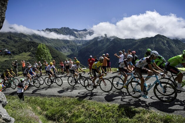(From R) Italy's Alberto Bettiol, Luxemburg's Ben Gastauer, France's Pierre-Roger Latour, Italy's Fabio Aru wearing the overall leader's yellow jersey, Spain's Mikel Nieve, Great Britain's Christopher Froome, Ireland's Daniel Martin and France's Romain Bardet ride past supporters during the 101 km thirteenth stage of the 104th edition of the Tour de France cycling race on July 14, 2017 between Saint-Girons and Foix. / AFP PHOTO / Jeff PACHOUD (Photo credit should read JEFF PACHOUD/AFP/Getty Images) (From R) Italy's Alberto Bettiol, Luxemburg's Ben Gastauer, France's Pierre-Roger Latour, Italy's Fabio Aru wearing the overall leader's yellow jersey, Spain's Mikel Nieve, Great Britain's Christopher Froome, Ireland's Daniel Martin and France's Romain Bardet ride past supporters during the 101 km thirteenth stage of the 104th edition of the Tour de France cycling race on July 14, 2017 between Saint-Girons and Foix. / AFP PHOTO / Jeff PACHOUD (Photo credit should read JEFF PACHOUD/AFP/Getty Images)
