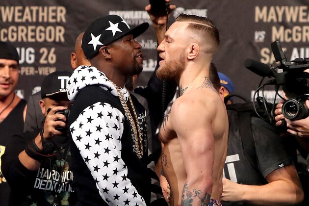 NEW YORK, NY - JULY 13: Floyd Mayweather Jr. and Conor McGregor face off during the Floyd Mayweather Jr. v Conor McGregor World Press Tour event at Barclays Center on July 13, 2017 in the Brooklyn borough of New York City. (Photo by Mike Lawrie/Getty Images) NEW YORK, NY - JULY 13: Floyd Mayweather Jr. and Conor McGregor face off during the Floyd Mayweather Jr. v Conor McGregor World Press Tour event at Barclays Center on July 13, 2017 in the Brooklyn borough of New York City. (Photo by Mike Lawrie/Getty Images)