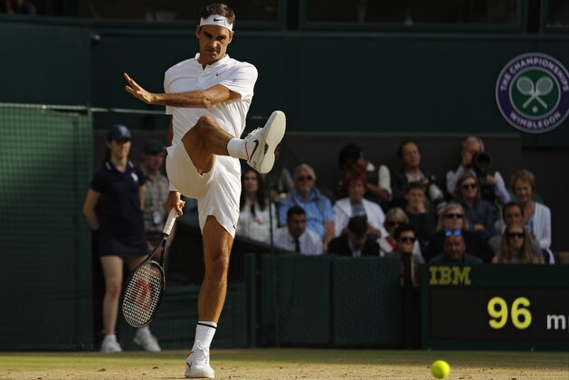 Switzerland's Roger Federer kicks the ball after an inconsistent bounce as he plays his Men's Singles semifinal match against Czech Republic's Tomas Berdych on day eleven at the Wimbledon Tennis Championships in London, Friday, July 14, 2017. (AP Photo/Alastair Grant)