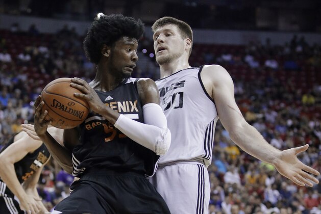 Phoenix Suns' Josh Jackson grabs a rebound next to Sacramento Kings' Jack Cooley during the first half of an NBA summer league basketball game, Friday, July 7, 2017, in Las Vegas. (AP Photo/John Locher)