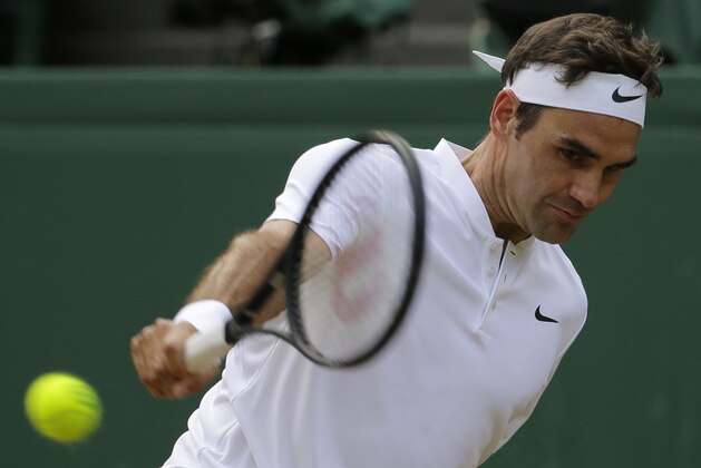 Switzerland's Roger Federer return a shot to Czech Republic's Tomas Berdych during their Men's Singles semifinal match on day eleven at the Wimbledon Tennis Championships in London Friday, July 14, 2017. (AP Photo/Alastair Grant)