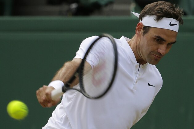 Switzerland's Roger Federer return a shot to Czech Republic's Tomas Berdych during their Men's Singles semifinal match on day eleven at the Wimbledon Tennis Championships in London Friday, July 14, 2017. (AP Photo/Alastair Grant)