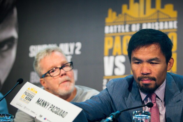Philippine boxer Manny Pacquiao (R) and trainer Freddie Roach attend a press conference to promote Pacquiao's WBO Welterweight title fight against Australian challenger Jeff Horn at Suncorp Stadium in Brisbane on June 28, 2017. 
Manny Pacquiao's world title fight with Jeff Horn will be 'short and sweet' with a knockout likely, his trainer predicted on June 28, as his Australian challenger said he was 'ready for war'.  / AFP PHOTO / Patrick HAMILTON / -- IMAGE RESTRICTED TO EDITORIAL USE - STRICTLY NO COMMERCIAL USE --        (Photo credit should read PATRICK HAMILTON/AFP/Getty Images)