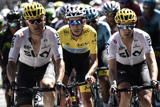 Italy's Fabio Aru (C), wearing the overall leader's yellow jersey, rides between Belarus' Vasil Kiryienka (L) and Spain's Mikel Landa during the 181,5 km fourteenth stage of the 104th edition of the Tour de France cycling race on July 15, 2017 between Blagnac and Rodez. / AFP PHOTO / Jeff PACHOUD        (Photo credit should read JEFF PACHOUD/AFP/Getty Images)