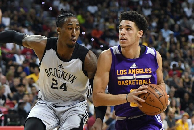 LAS VEGAS, NV - JULY 15:  Lonzo Ball #2 of the Los Angeles Lakers drives against Rondae Hollis-Jefferson #24 of the Brooklyn Nets during the 2017 Summer League at the Thomas & Mack Center on July 15, 2017 in Las Vegas, Nevada. NOTE TO USER: User expressly acknowledges and agrees that, by downloading and or using this photograph, User is consenting to the terms and conditions of the Getty Images License Agreement.  (Photo by Ethan Miller/Getty Images)