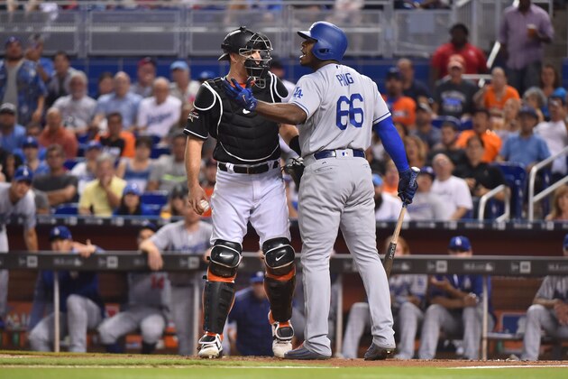 MIAMI, FL - JULY 15: J.T. Realmuto #11 of the Miami Marlins holds back Yasiel Puig #66 of the Los Angeles Dodgers after a close pitch in the first inning at Marlins Park on July 15, 2017 in Miami, Florida. (Photo by Eric Espada/Getty Images)