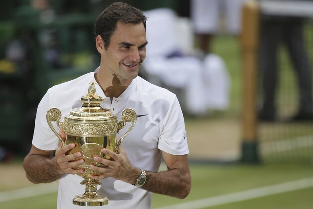 Switzerland's Roger Federer holds the trophy after defeating Croatia's Marin Cilic to win the Men's Singles final match on day thirteen at the Wimbledon Tennis Championships in London Sunday, July 16, 2017.. (AP Photo/Tim Ireland)