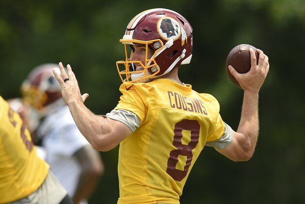 FILE - In this June 14, 2017, file photo, Washington Redskins quarterback Kirk Cousins (8) looks to pass during NFL football practice, in Ashburn, Va. With the deadline for a long-term deal with Kirk Cousins looming, Eric Schaffer, the team's