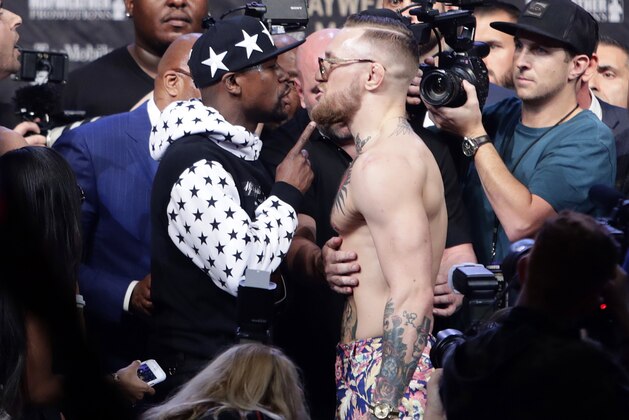 Floyd Mayweather Jr., left, and Conor McGregor exchange words during a news conference at Barclays Center on Thursday, July 13, 2017, in New York. (AP Photo/Frank Franklin II)