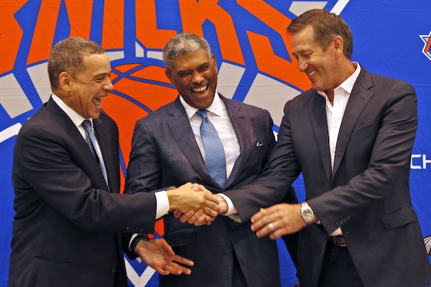New York Knicks general manager Scott Perry, left, shakes hands with head coach Jeff Hornacek, right, while posing for a picture along with new president Steve Mills, during a news conference in in Greenburgh, N.Y., Monday, July 17, 2017. (AP Photo/Seth Wenig)