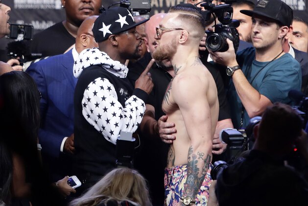 Floyd Mayweather Jr., left, and Conor McGregor exchange words during a news conference at Barclays Center on Thursday, July 13, 2017, in New York. (AP Photo/Frank Franklin II)