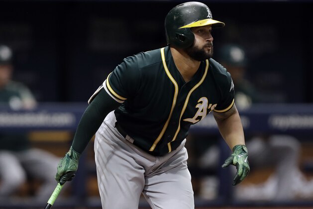 Oakland Athletics' Yonder Alonso watches his RBI single off Tampa Bay Rays pitcher Erasmo Ramirez during the third inning of the first game of a scheduled baseball doubleheader Saturday, June 10, 2017, in St. Petersburg, Fla. Athletics' Jed Lowrie scored.(AP Photo/Chris O'Meara)