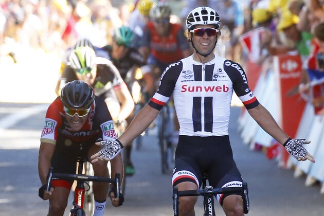 Australia's Michael Matthews celebrates as he crosses the finish line to win the fourteenth stage of the Tour de France cycling race over 181.5 kilometers (112.8 miles) with start in Blagnac and finish in Rodez, France, Saturday, July 15, 2017. Belgium's Thomas De Gendt, left, finished second. (AP Photo/Christophe Ena)