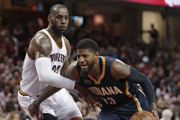 Indiana Pacers' Paul George, right, drives against Cleveland Cavaliers' LeBron James during the second half of an NBA basketball game, Sunday, April 2, 2017, in Cleveland. The Cavaliers won 135-130 in double overtime. (AP Photo/Tony Dejak)