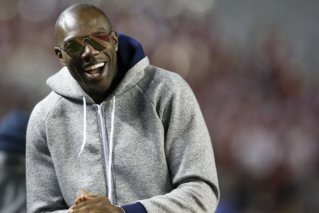 Former NFL wide receiver and Chattanooga alum Terrell Owens walks the sidelines during the second half of an NCAA college football game with Alabama and Chattanooga, Saturday, Nov. 19, 2016, in Tuscaloosa, Ala. (AP Photo/Brynn Anderson)