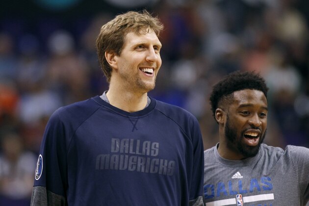 Dallas Mavericks forward Dirk Nowitzki, left, and teammate Wesley Matthews laugh during pre-game warm up before an NBA basketball game against the Phoenix Suns, Sunday, April 9, 2017, in Phoenix. The Suns defeated the Mavericks 124-111. (AP Photo/Ralph Freso)