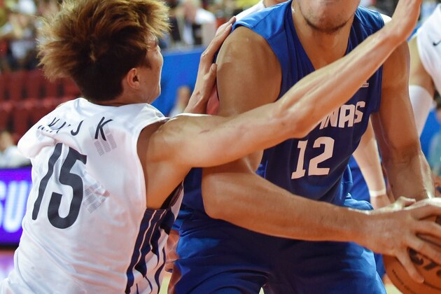 June Mar Fajardo of the Philippines (C) competes with Kim Jong-Kyu of South Korea (L) during their men's quarter-final group H basketball match at Samsan World Gymnasium Ground during the 17th Asian Games in Incheon on September 27, 2014. AFP PHOTO / Bay ISMOYO (Photo credit should read BAY ISMOYO/AFP/Getty Images) June Mar Fajardo of the Philippines (C) competes with Kim Jong-Kyu of South Korea (L) during their men's quarter-final group H basketball match at Samsan World Gymnasium Ground during the 17th Asian Games in Incheon on September 27, 2014. AFP PHOTO / Bay ISMOYO (Photo credit should read BAY ISMOYO/AFP/Getty Images)