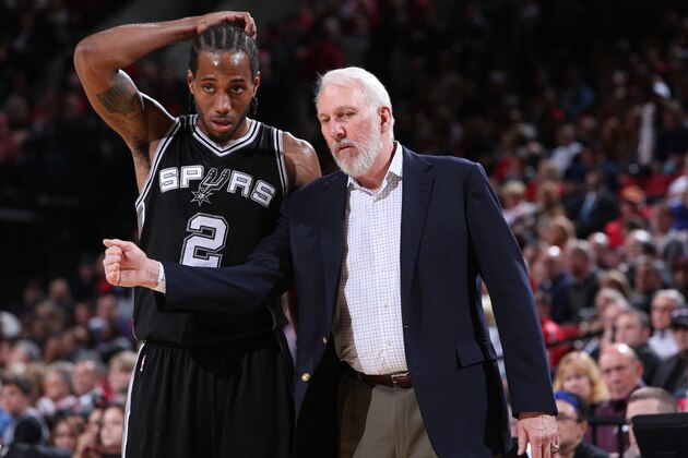 PORTLAND, OR - DECEMBER 15:  Kawhi Leonard #2 and Gregg Popovich of the San Antonio Spurs talk against the Portland Trail Blazers on December 15, 2014 at the Moda Center Arena in Portland, Oregon. NOTE TO USER: User expressly acknowledges and agrees that, by downloading and or using this photograph, user is consenting to the terms and conditions of the Getty Images License Agreement. Mandatory Copyright Notice: Copyright 2014 NBAE (Photo by Sam Forencich/NBAE via Getty Images)