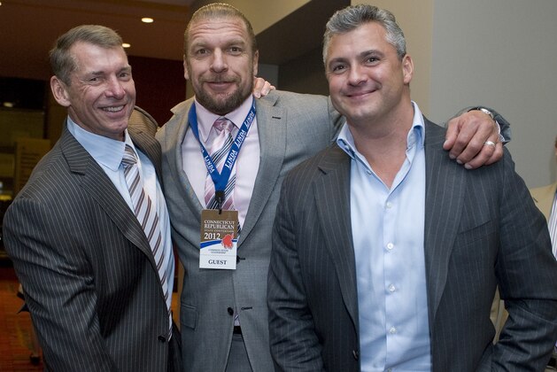 Vince McMahon, left, poses for a photo with son-in-law Paul Levesque as known as the wrestler Triple H and son Shane McMahon, right, at the Republican state convention in Hartford, Conn., Friday, May 18, 2012.  (AP Photo/Jessica Hill)