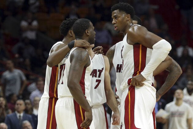 Miami Heat guard Dion Waiters (11) talks with center Hassan Whiteside, right, during the second half of an NBA basketball game against the Milwaukee Bucks, Thursday, Nov. 17, 2016, in Miami. The Heat defeated the Bucks 96-73. (AP Photo/Lynne Sladky)
