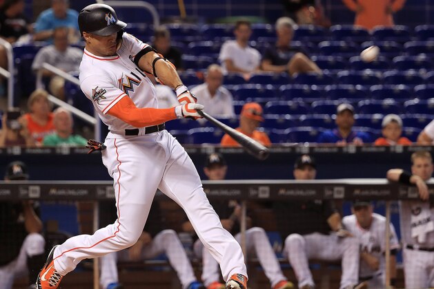 MIAMI, FL - JULY 19:  Giancarlo Stanton #27 of the Miami Marlins hits a solo home run in the first inning during a game against the Philadelphia Phillies at Marlins Park on July 19, 2017 in Miami, Florida.  (Photo by Mike Ehrmann/Getty Images)