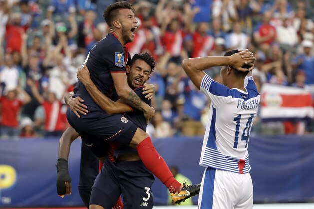 Costa Rica players celebrate an own goal in front of Panama's Valentin Pimentel (14) during a CONCACAF Gold Cup quarterfinal soccer match in Philadelphia, Wednesday, July 19, 2017. (AP Photo/Matt Rourke)