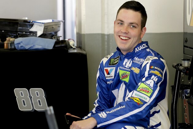 Alex Bowman smiles to team members in his garage during a practice session for the Clash NASCAR auto race at Daytona International Speedway, Friday, Feb. 17, 2017, in Daytona Beach, Fla. (AP Photo/Terry Renna)
