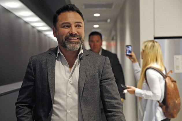 Ten-time boxing title holder and boxing promoter Oscar de la Hoya walks down a hallway prior to an interview with one of his boxers, eight-time title holder Saul