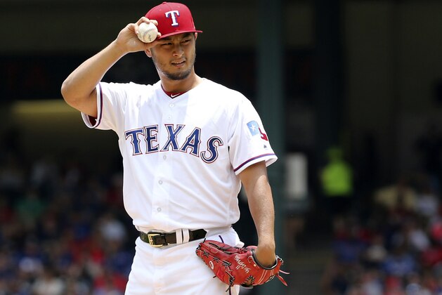 Texas Rangers starting pitcher Yu Darvish adjusts his cap as he works the first inning of a baseball game against the Los Angeles Angels in Arlington, Texas, Sunday, July 9, 2017. (AP Photo/ Richard W. Rodriguez)