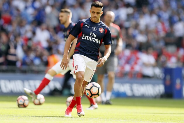 Arsenal's Alexis Sanchez plays with a ball during warm up before the English FA Cup final soccer match between Arsenal and Chelsea at Wembley stadium in London, Saturday, May 27, 2017. (AP Photo/Kirsty Wigglesworth)