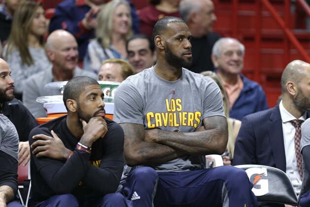 Cleveland Cavaliers guard Kyrie Irving, left, and forward LeBron James watch from the bench during the first half of an NBA basketball game against the Miami Heat, Saturday, March 4, 2017, in Miami. (AP Photo/Lynne Sladky)