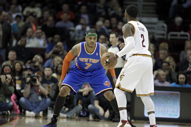New York Knicks' Carmelo Anthony (7) guards Cleveland Cavaliers' Kyrie Irving in an NBA basketball game Friday, April 12, 2013, in Cleveland. (AP Photo/Mark Duncan)
