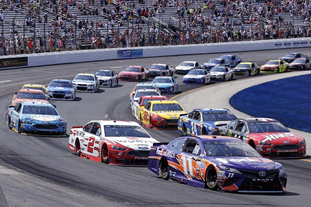 Driver Denny Hamlin (11) and the pack race during the NASCAR Cup Series 301 auto race at the New Hampshire Motor Speedway in Loudon, N.H., Sunday, July 16, 2017. Hamlin won the race. (AP Photo/Charles Krupa)