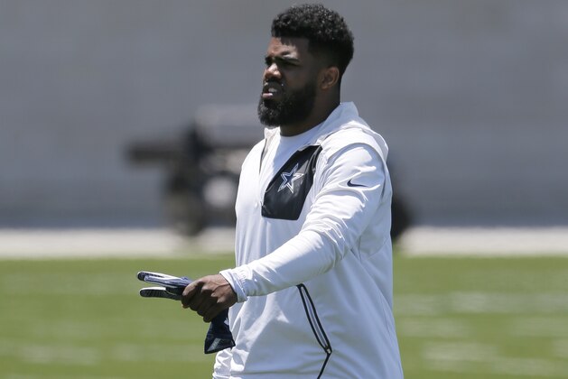 Dallas Cowboys running back Ezekiel Elliott (21) walks off the field carrying his helmet after an NFL football organized team activities practice at the team's training facility, Wednesday, May 24, 2017, in Frisco, Texas. (AP Photo/Tony Gutierrez)