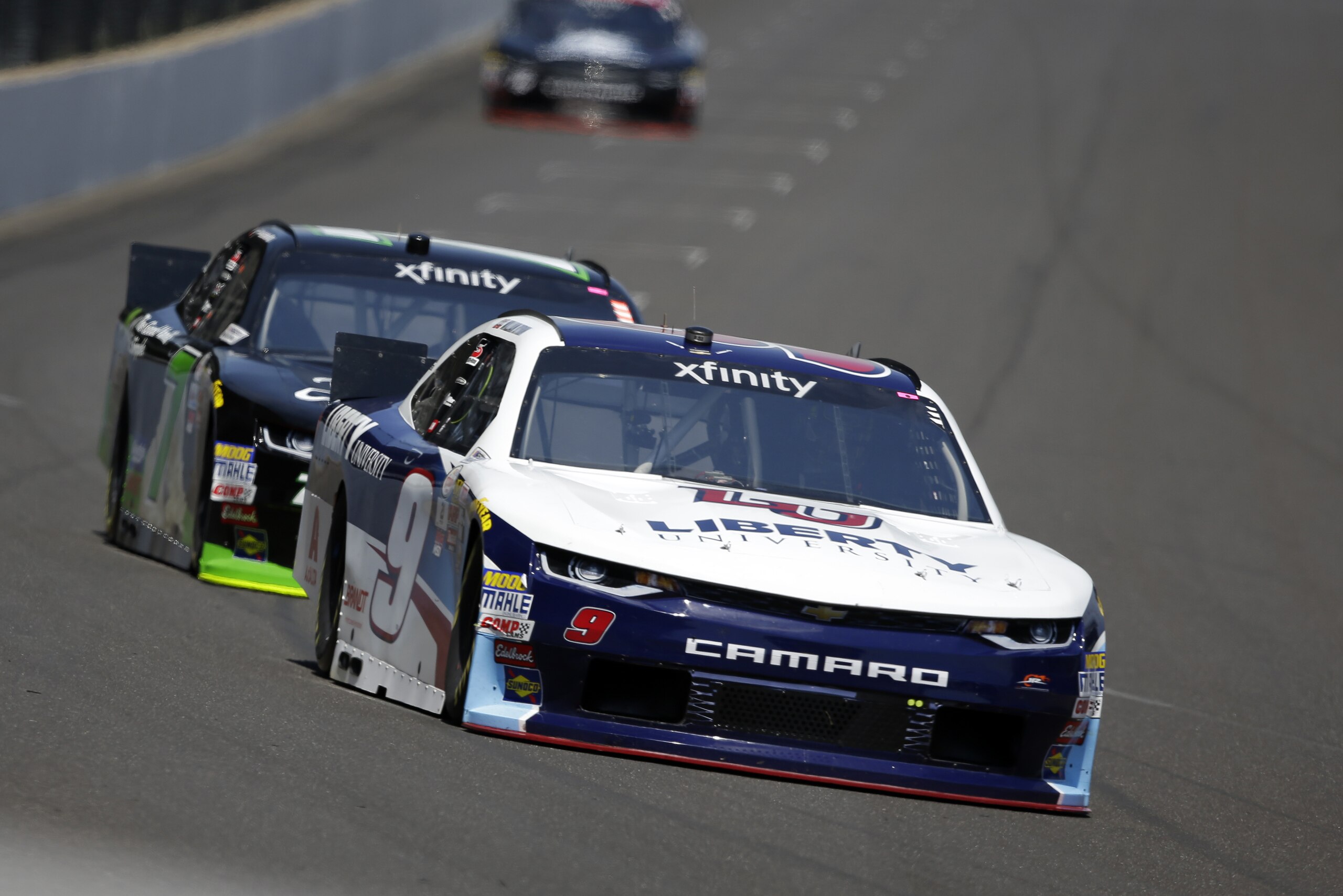 Race driver William Byron leads Justin Allgaier into the first turn during practice for the NASCAR XFINITY series auto race at Indianapolis Motor Speedway, in Indianapolis Friday, July 21, 2017. (AP Photo/Michael Conroy)