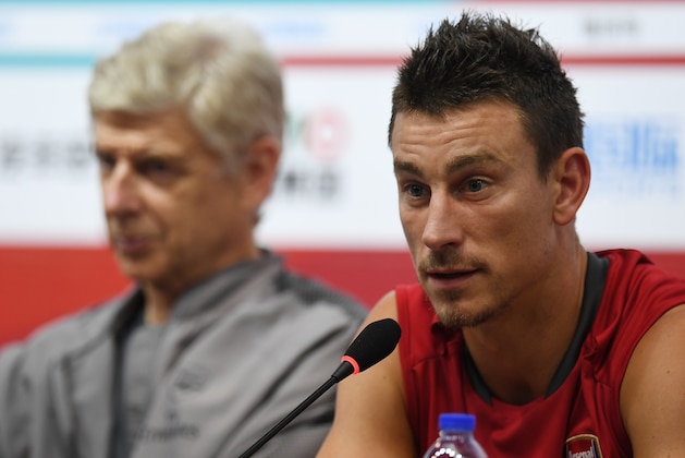 Arsenal's Laurent Koscielny (R) speaks at a press conference as coach Arsene Wenger looks on after a football training session in Beijing's National Stadium, known as the Bird's Nest, on July 21, 2017.
Arsenal will play Chelsea at the Bird's Nest on July 22. / AFP PHOTO / GREG BAKER        (Photo credit should read GREG BAKER/AFP/Getty Images)