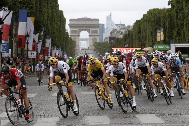 Britain's Chris Froome, wearing the overall leader's yellow jersey, center, rides on the Champs Elysees avenue during the twenty-first and last stage of the Tour de France cycling race over 103 kilometers (64 miles) with start in Montgeron and finish in Paris, France, Sunday, July 23, 2017. (AP Photo/Thibault Camus) Britain's Chris Froome, wearing the overall leader's yellow jersey, center, rides on the Champs Elysees avenue during the twenty-first and last stage of the Tour de France cycling race over 103 kilometers (64 miles) with start in Montgeron and finish in Paris, France, Sunday, July 23, 2017. (AP Photo/Thibault Camus)