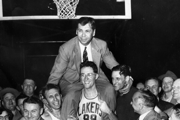 FILE - In this April 25, 1952, file photo, Minneapolis Lakers coach John Kundla, top, is hoisted up by players and carried to their dressing room after beating the New York Knickerbockers 82-65 to win their fourth NBA basketball championship in five years. The Lakers left Minneapolis for Los Angeles and concerns are now rising that the Minnesota Vikings will leave if the state fails to build a new stadium. (AP Photo, File)