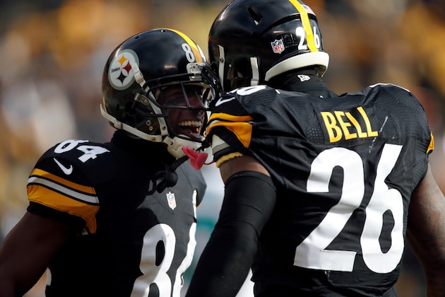 PITTSBURGH, PA - JANUARY 08:  Antonio Brown #84 of the Pittsburgh Steelers celebrates with teammate Le'Veon Bell #26 after scoring his second touchdown during the first quarter against the Miami Dolphins in the AFC Wild Card game at Heinz Field on January 8, 2017 in Pittsburgh, Pennsylvania.  (Photo by Gregory Shamus/Getty Images)