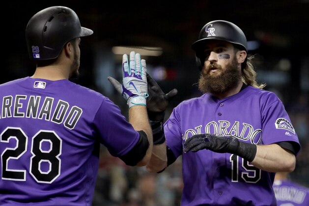 Colorado Rockies' Charlie Blackmon greets Nolan Arenado (28) after hitting a solo home run during the first inning of a baseball game against the Arizona Diamondbacks, Friday, June 30, 2017, in Phoenix. (AP Photo/Matt York)