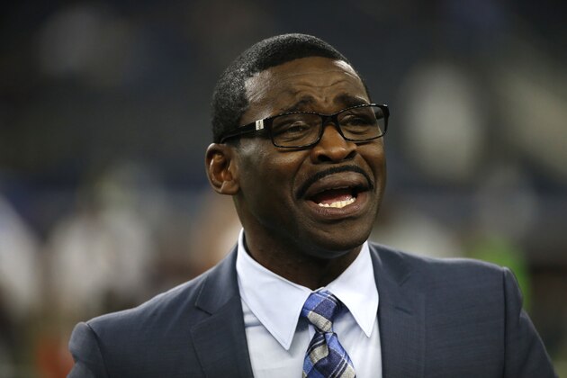 Broadcast personality and former Dallas Cowboys player Michael Irvin talks with persons on the field before a preseason NFL football game against the Houston Texans on Thursday Sept. 1, 2016, in Arlington, Texas. (AP Photo/Ron Jenkins)