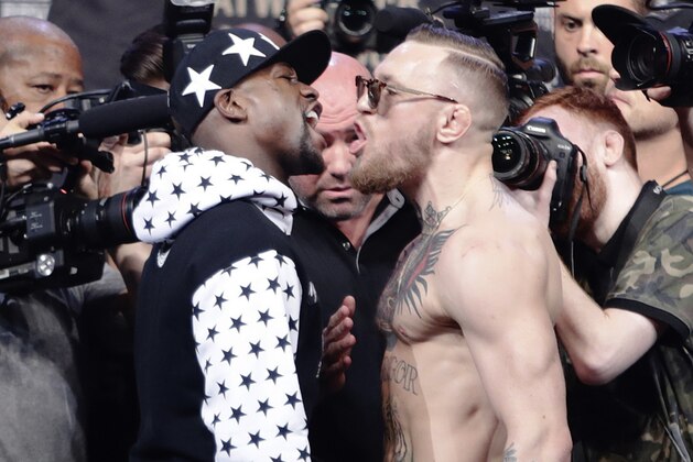 Conor McGregor, right, reacts as Floyd Mayweather Jr., left, jaw during a news conference at Barclays Center on Thursday, July 13, 2017, in New York. (AP Photo/Frank Franklin II)