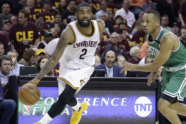 Cleveland Cavaliers' Kyrie Irving (2) drives around Boston Celtics' Avery Bradley (0) during the second half of Game 3 of the NBA basketball Eastern Conference finals, Sunday, May 21, 2017, in Cleveland. (AP Photo/Tony Dejak)