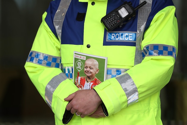 SUNDERLAND, ENGLAND - MAY 13: A police officer is seen holding the match day programme displaying a image of Bradley Lowery outside the stadium prior to the Premier League match between Sunderland and Swansea City at Stadium of Light on May 13, 2017 in Sunderland, England.  (Photo by Ian MacNicol/Getty Images)