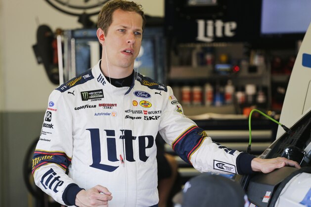 Brad Keselowski gets ready to get into his car during a practice session for the Clash NASCAR auto race at Daytona International Speedway, Friday, Feb. 17, 2017, in Daytona Beach, Fla. (AP Photo/Terry Renna)
